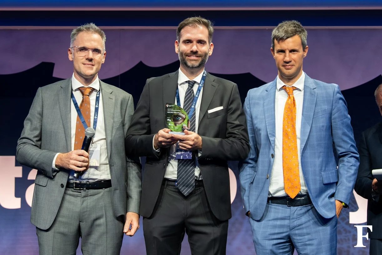 Representatives of a recognised company holding their Sustainability Award 2026 trophy on stage