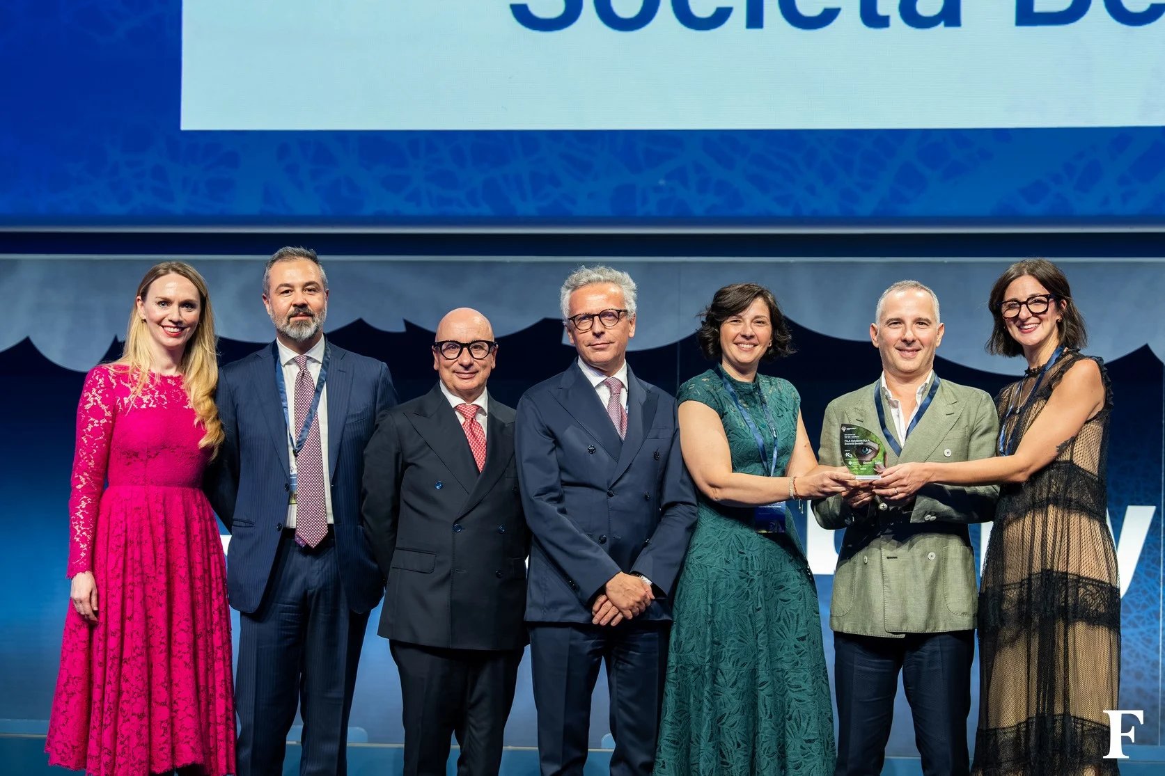 A group of company representatives and presenters holding a Sustainability Award 2026 trophy